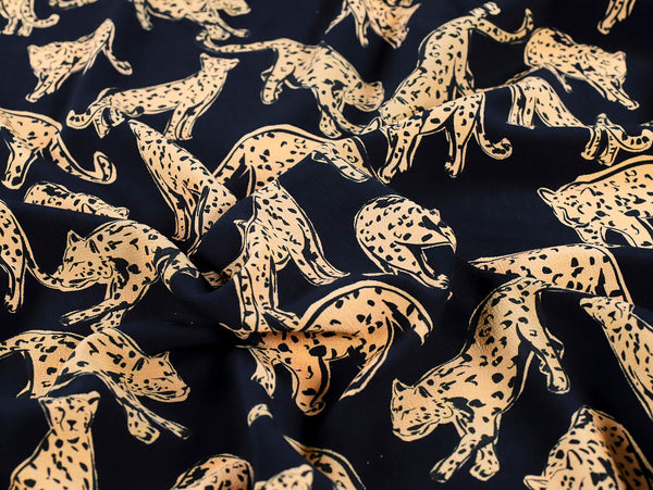 Pattern of leopards on a dark blue fabric