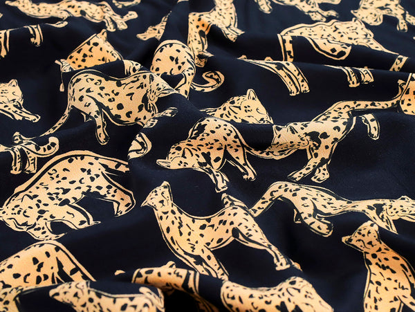 Navy blue fabric with gold leopard print pattern