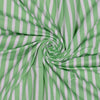 Green and white striped fabric in a swirl pattern