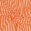 Close-up of orange and white striped fabric in a swirl pattern