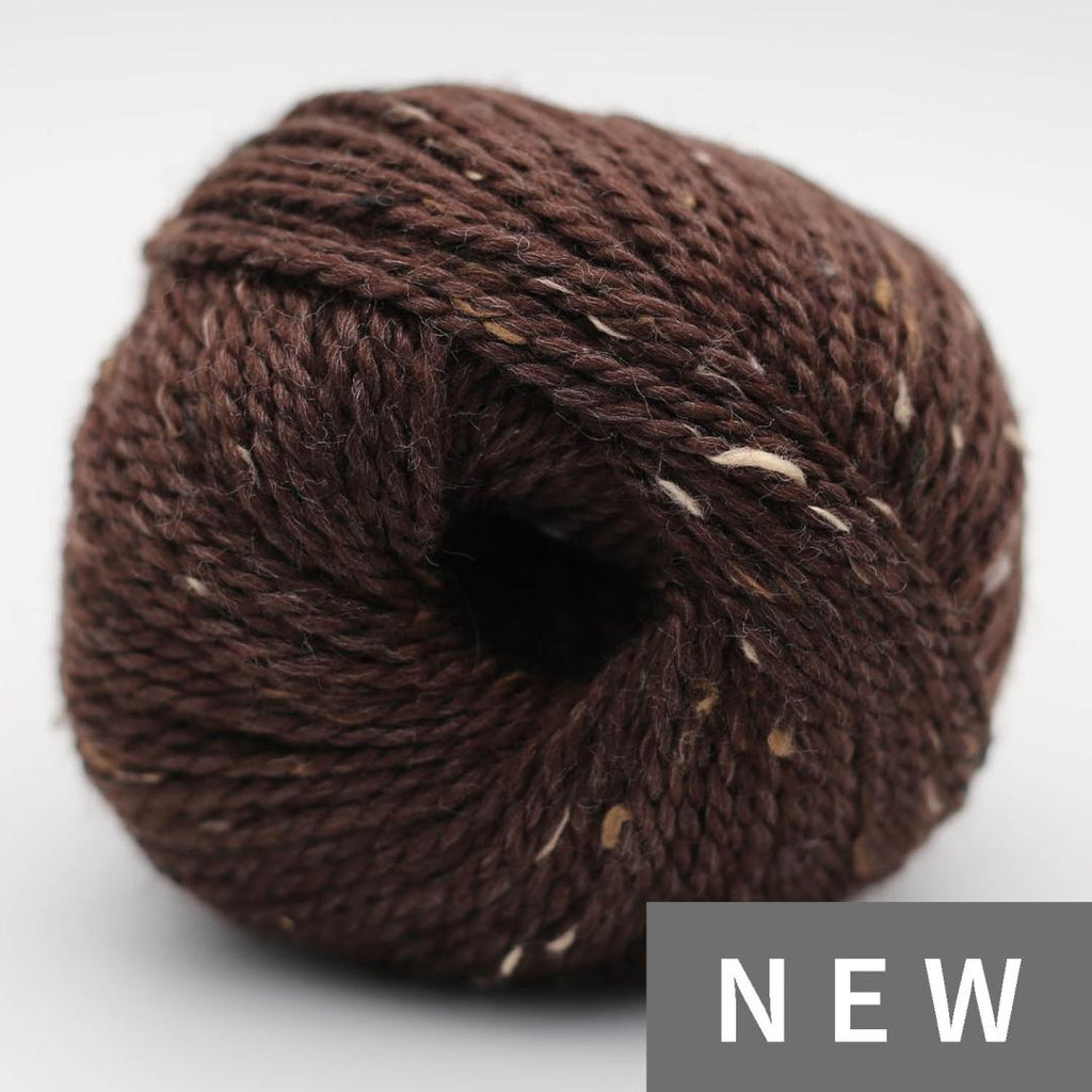 Brown skein of yarn with 'NEW' label on a light gray background