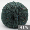 Green skein of yarn with multicolored speckles on a white background, labeled 'NEW'.