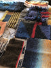 Collection of woven fabric samples with various patterns and colors.