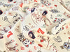 Fabric with vintage-style playing card design on a beige background
