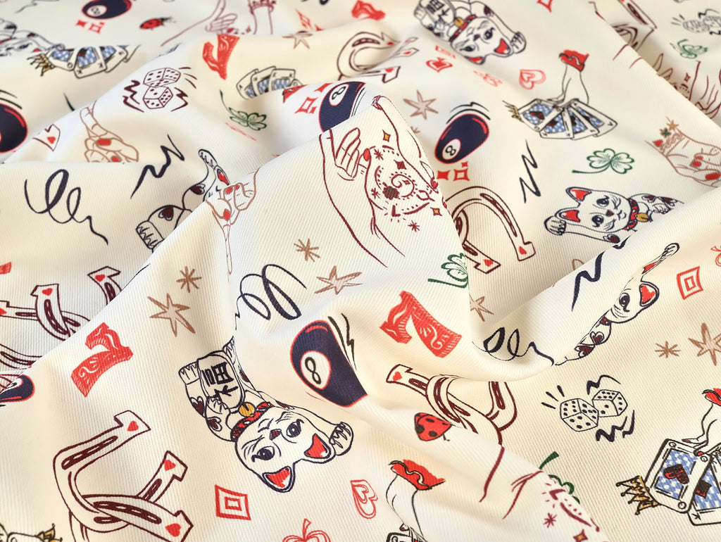 Fabric with vintage-style playing card design on a beige background