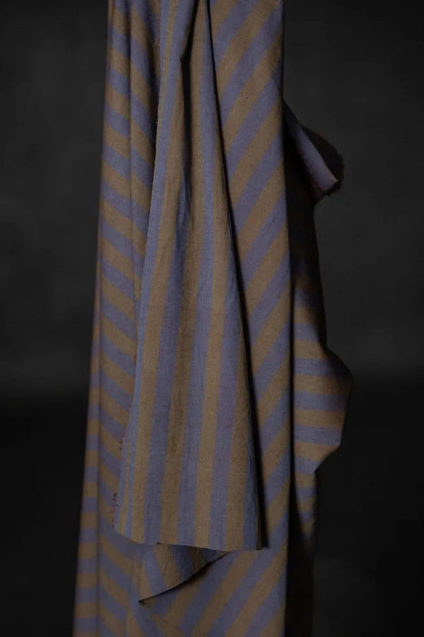 Striped fabric with blue and yellow pattern on a dark background