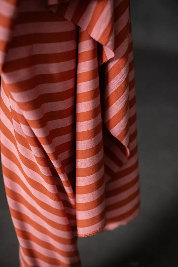 Red and white striped fabric on a dark background
