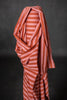 Striped fabric with red and white pattern on a dark background