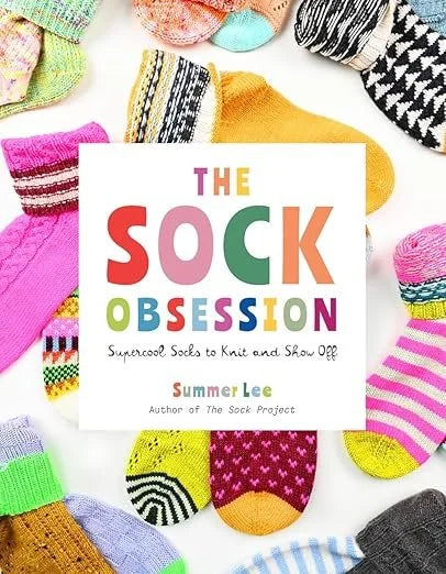 Book titled 'The Sock Obsession' by Summer Lee surrounded by colorful socks on a white background