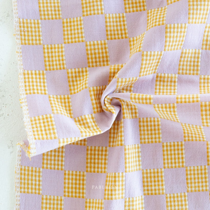Yellow and white checkered fabric on a white background