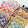 Collection of colorful checkered fabric swatches on a light background