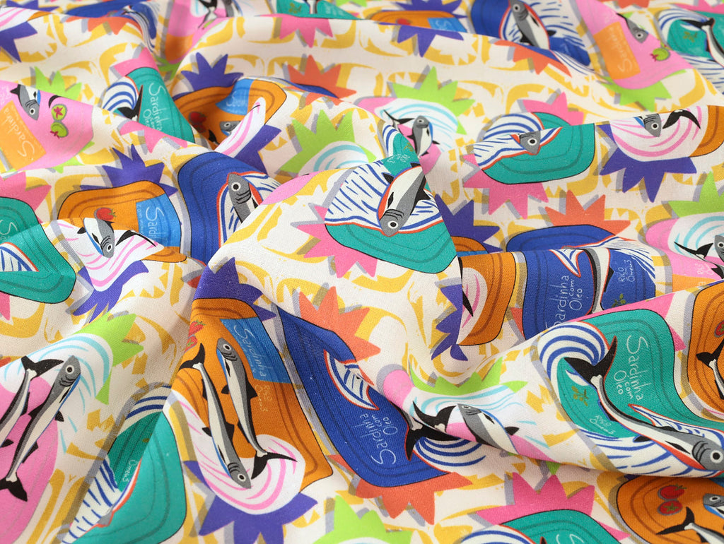 Colorful fabric with bird patterns and 'Sue Clancy' branding.