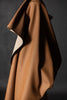 Brown fabric draped over a dark background