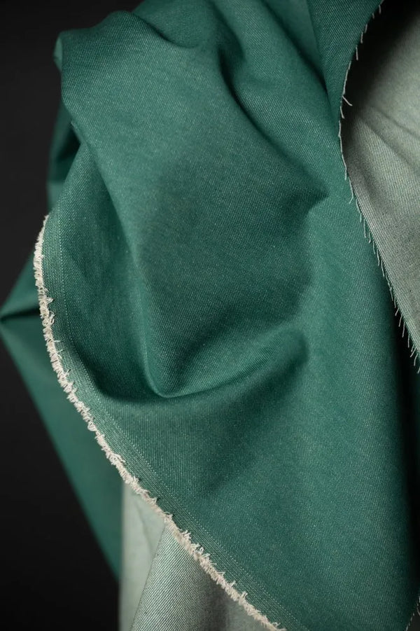 Close-up of green fabric with a dark background