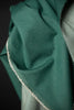 Close-up of green fabric with a dark background