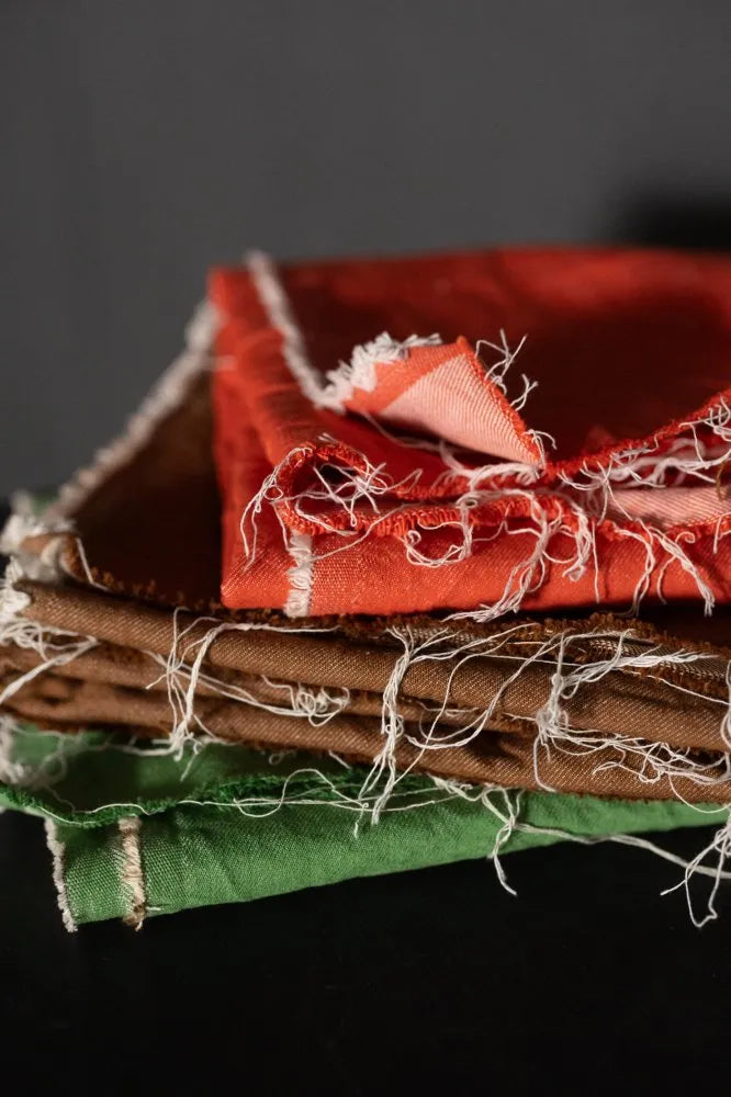 Stack of colorful fabric squares on a dark background