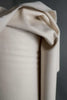 Close-up of beige fabric with a dark background