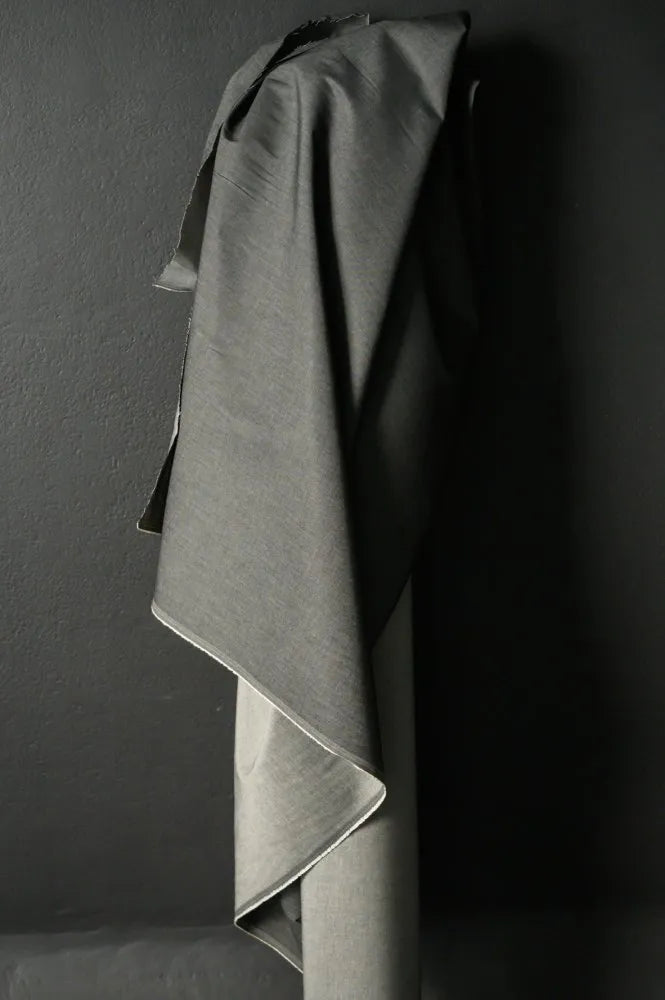 Gray fabric draped over a dark surface
