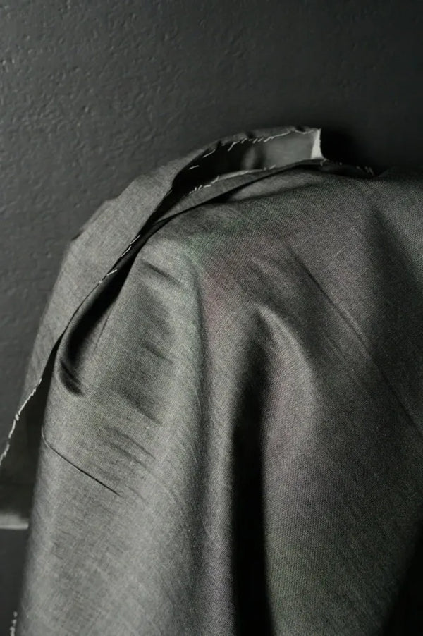 Close-up of a dark fabric texture against a dark background