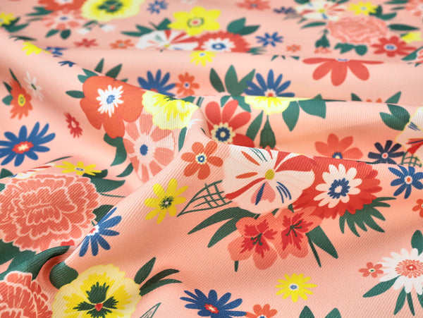 Floral fabric pattern with colorful flowers on a peach background