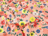 Floral fabric pattern with colorful flowers on a pink background
