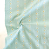 Light blue fabric with small white floral patterns on a light background