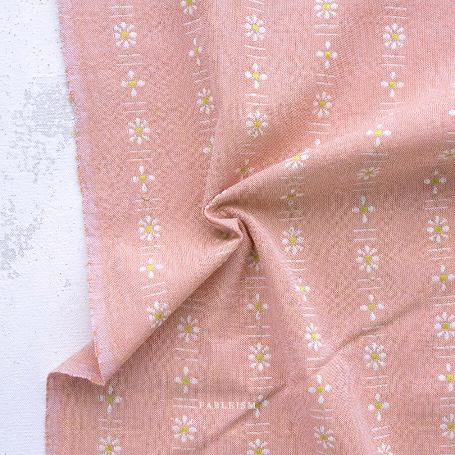 Pink fabric with white floral pattern on a white background