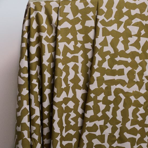 Two pieces of viscose crepe fabric in beige with a geometric pattern and black with a floral pattern, laid flat.