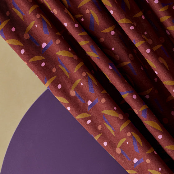 Brown fabric with abstract pattern on a geometric background