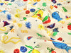 Colorful fabric with various patterns and shapes on a beige background