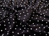 Black fabric with white polka dots
