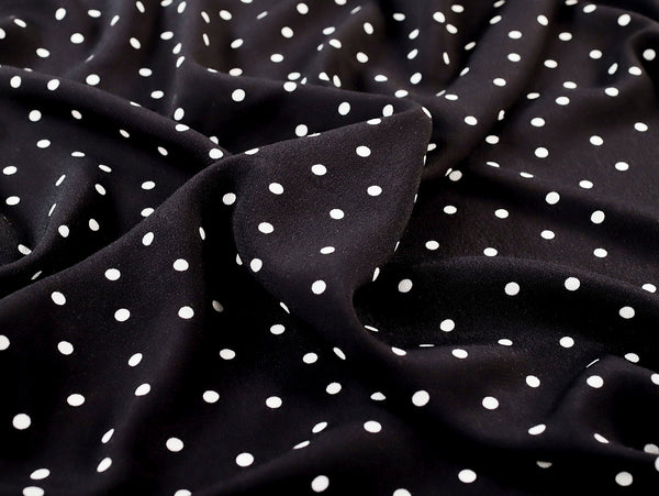 Black fabric with white polka dots