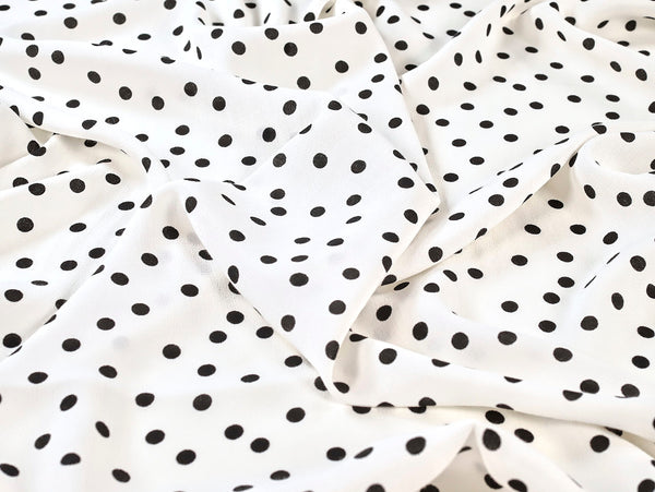 White fabric with black polka dot pattern