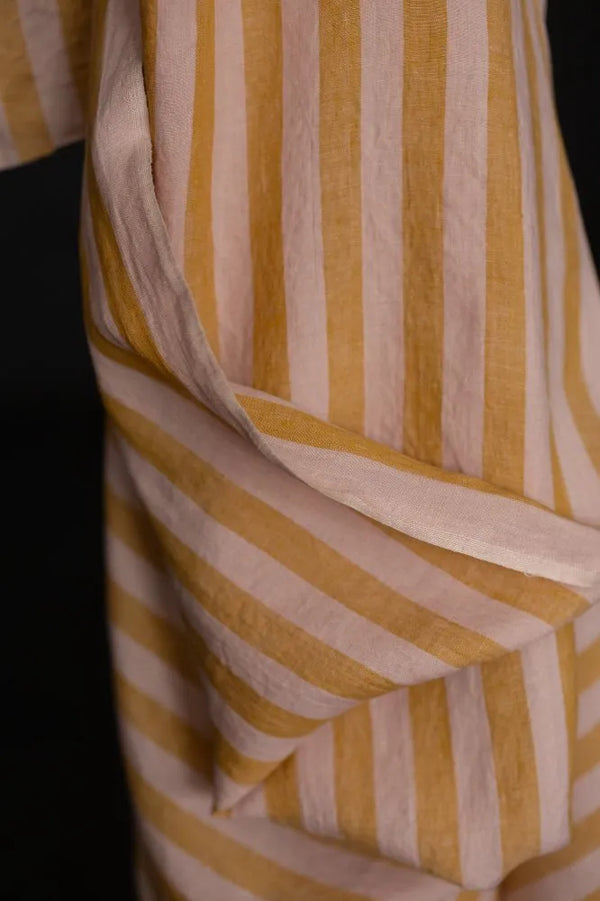 Close-up of a fabric with yellow and beige stripes on a black background