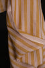 Close-up of a fabric with yellow and beige stripes on a black background