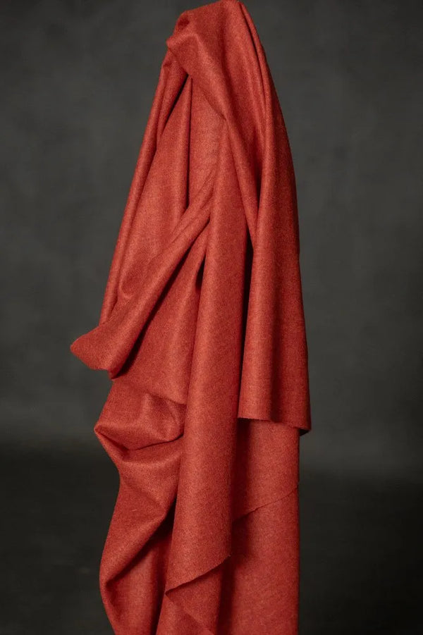 Red fabric draped over a dark background