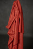 Red fabric draped over a dark background