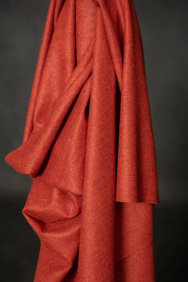 Red fabric draped over a dark background