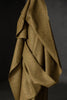 Brown fabric draped over a black background