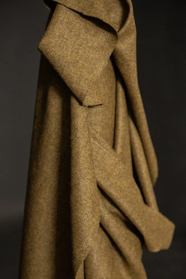 Close-up of a brown fabric texture against a dark background