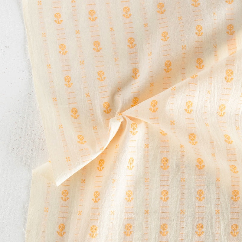 Sheer fabric with small floral patterns on a light background