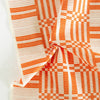 Close-up of orange and white checkered fabric on a white background