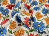 Colorful floral pattern on fabric with blue, red, orange, and yellow flowers.