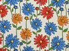 Pattern of colorful flowers including blue, red, and orange on a beige background.