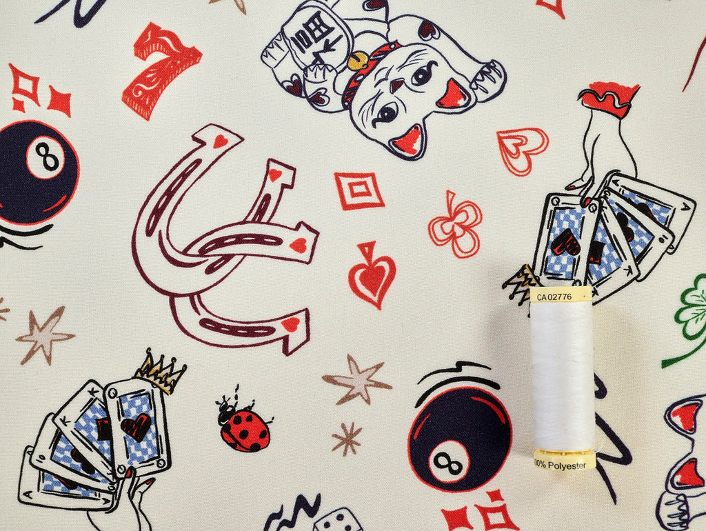Decorative bottle with playing card design on a patterned background