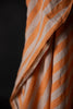 a close up of orange stripe linen fabric