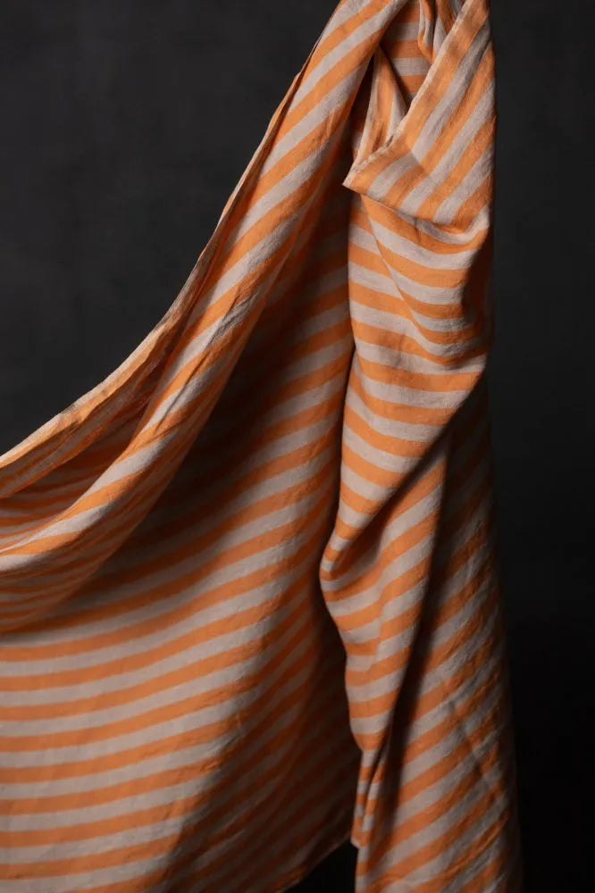 a swatch of linen striped fabric against a dark background