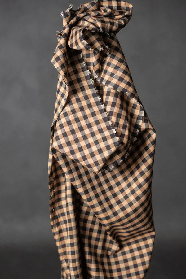 Checkered fabric with ruffled edges on a dark background