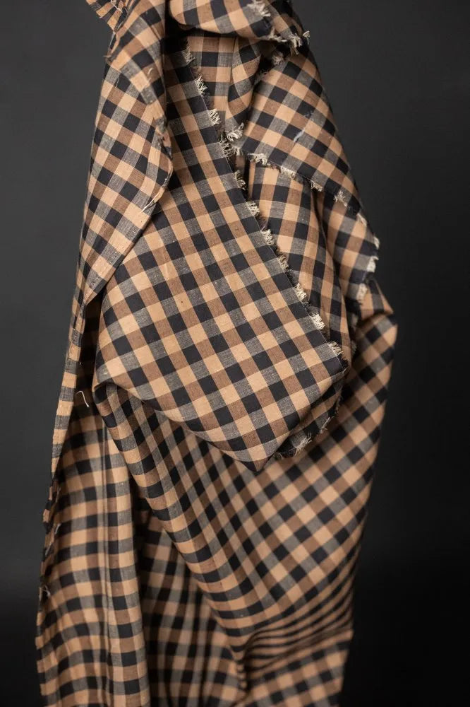 Checkered fabric with ruffled edges on a dark background