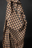 Checkered fabric with ruffled edges on a dark background